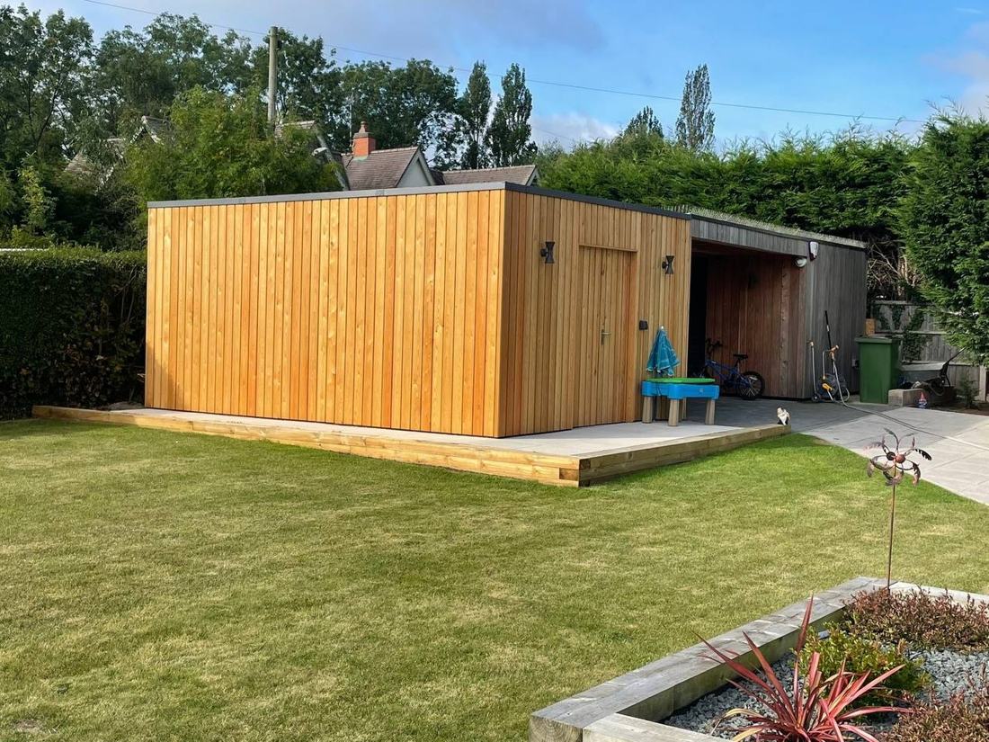 Larch-clad garden building on a decked base