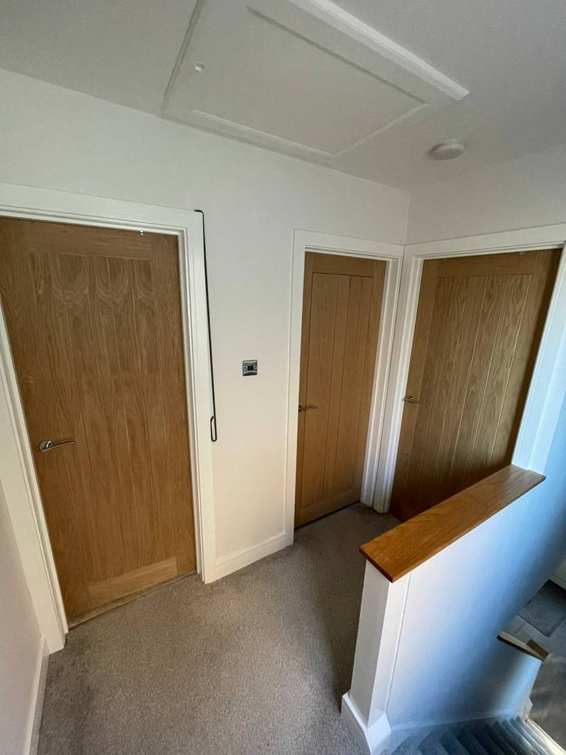 Oak doors on a landing with an oak-capped half wall