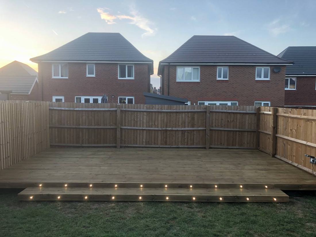 Timber decking with built-in lights at dusk