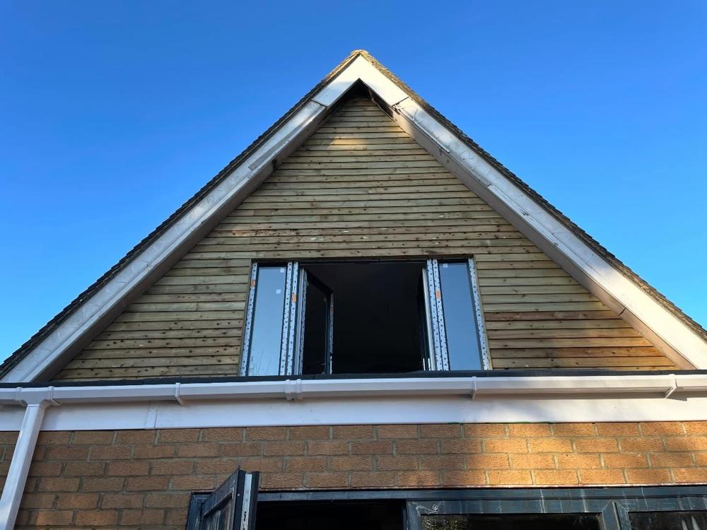 Timber cladding around a set of bifold doors