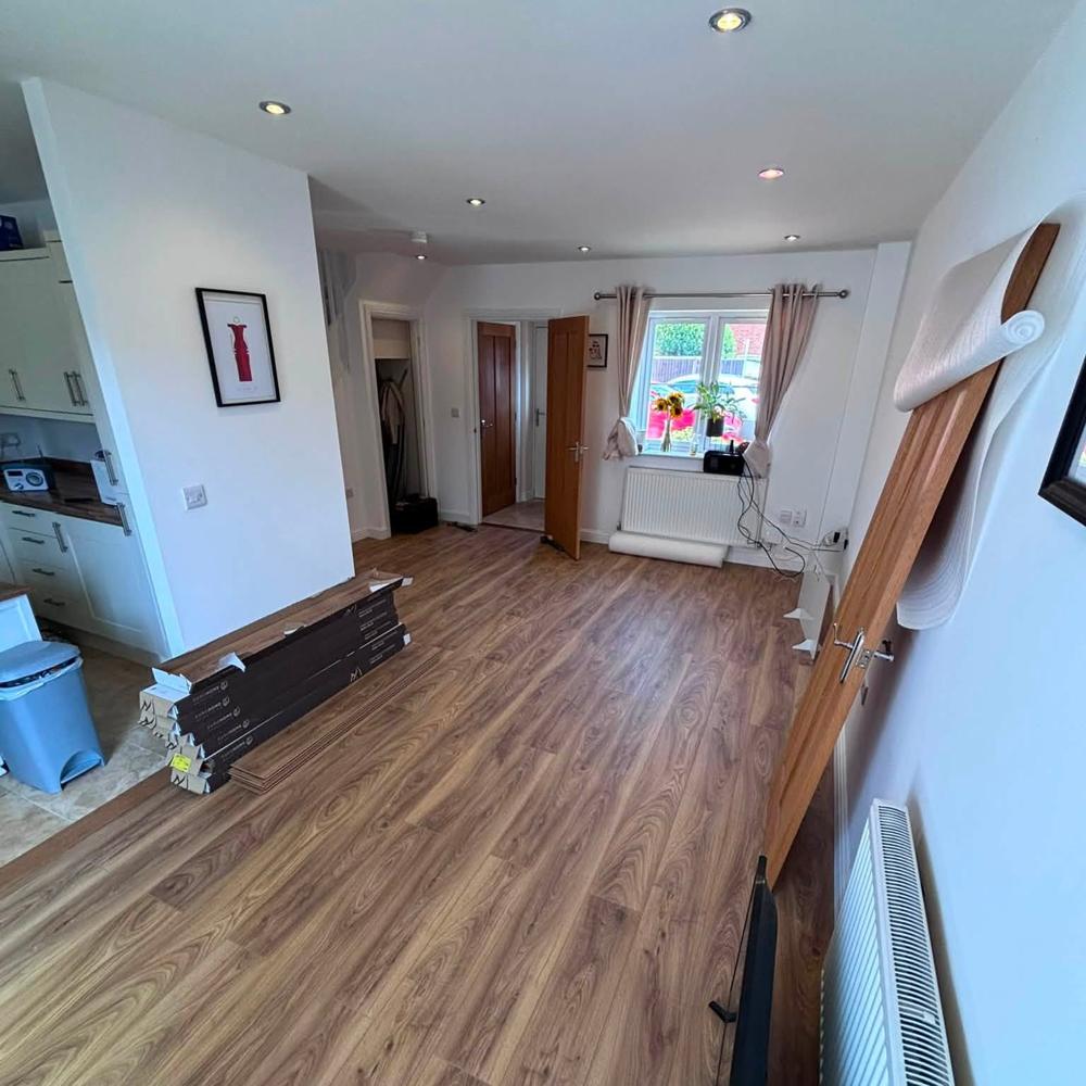 New wood-effect flooring laid through a living room