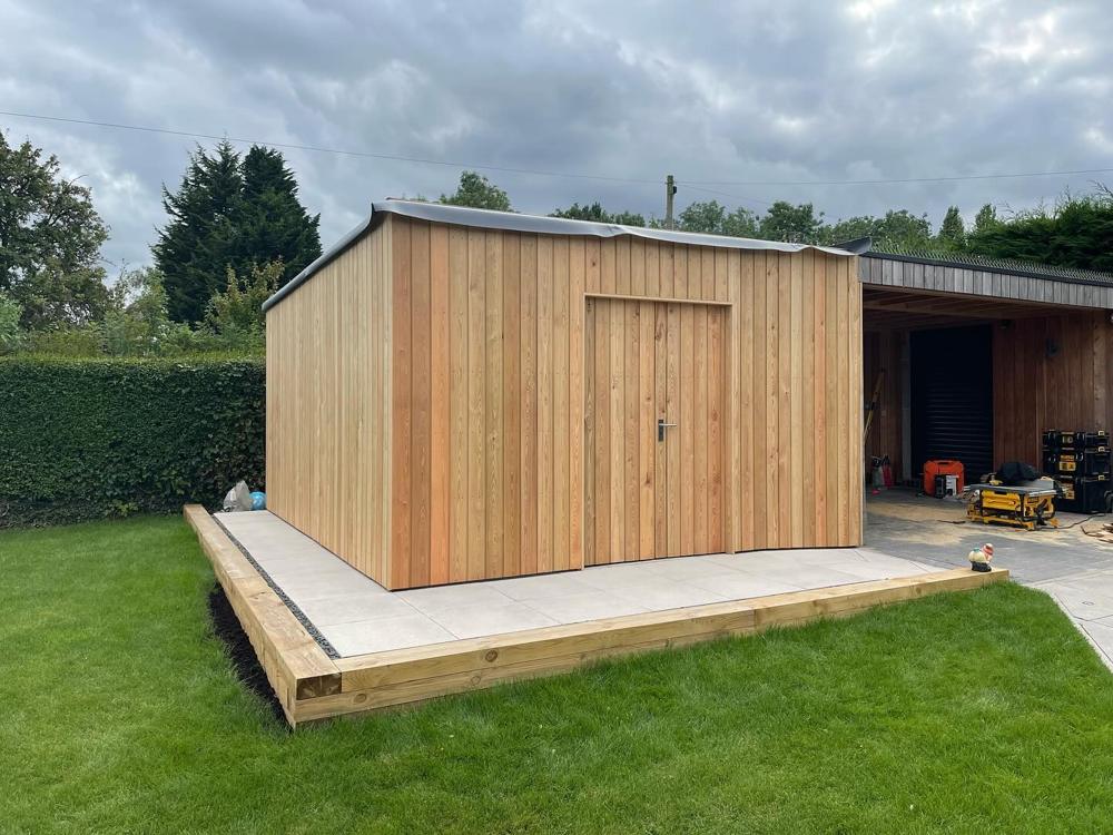 Larch-clad garden building on a deck