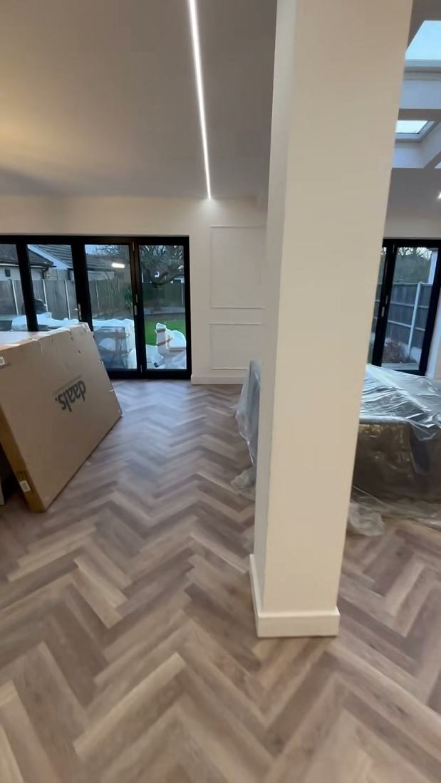 Open-plan kitchen with island and herringbone floor