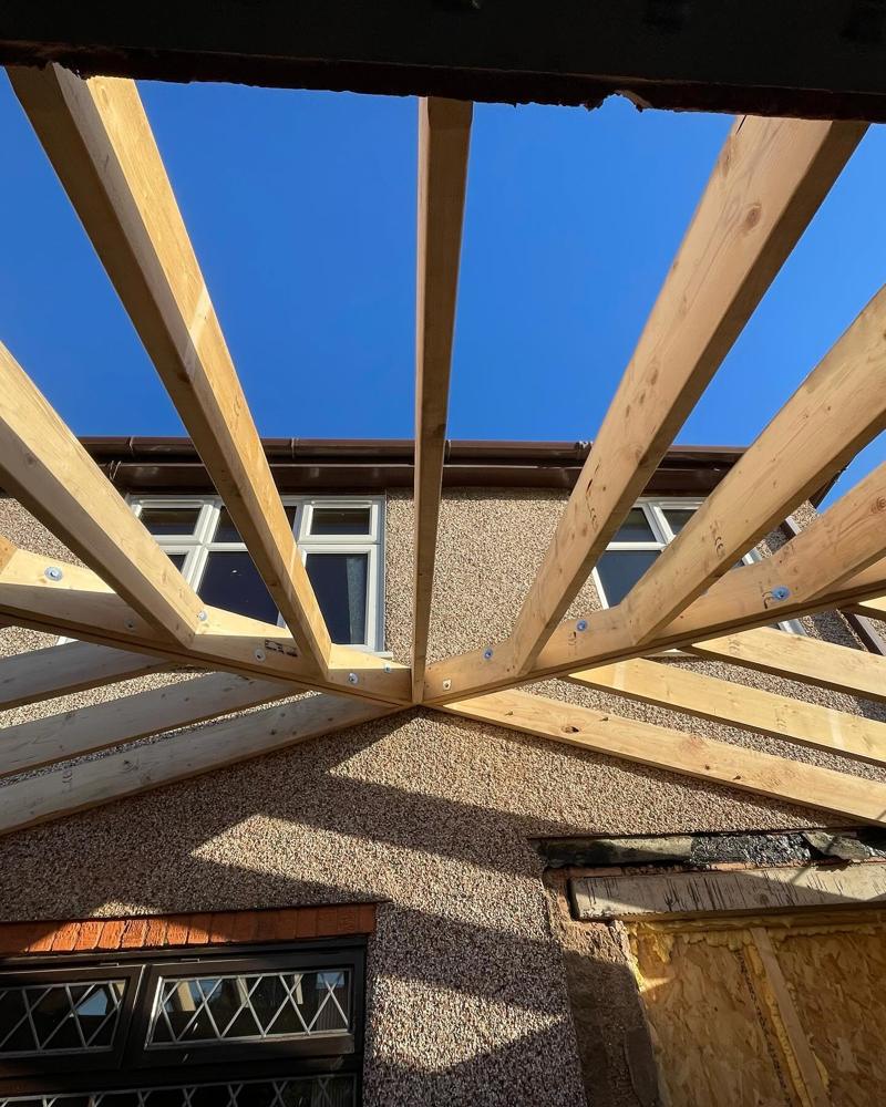New timber rafters against a blue sky