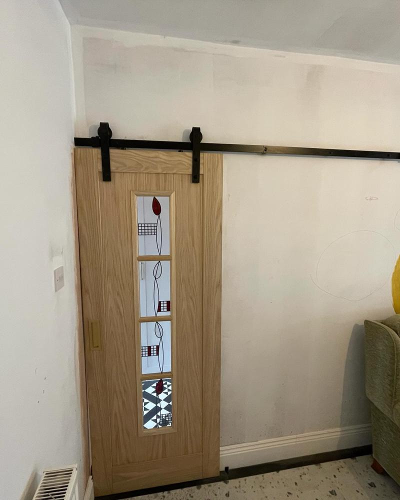 Sliding oak barn door with glazed panel